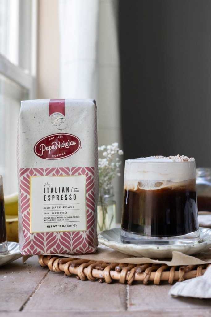 The banana bread cold brew next to a bag of coffee.