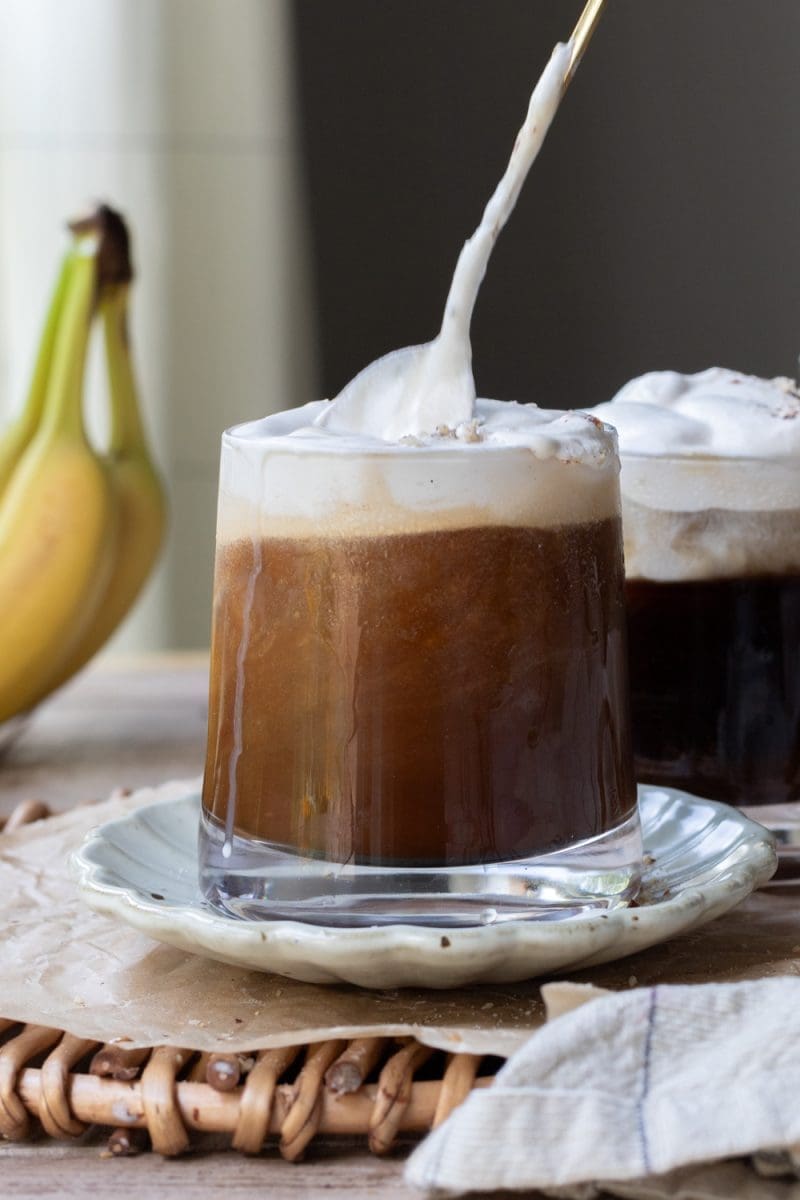 Mixing the cold foam into the banana bread cold brew.