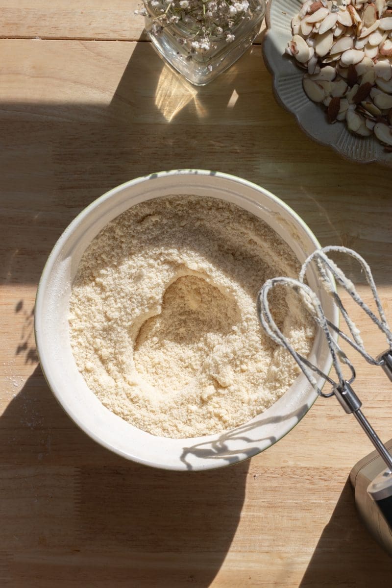 The dry ingredients and butter beaten together in a mixing bowl.