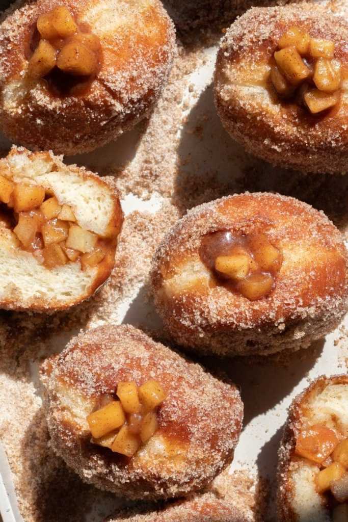 Close up of the filled apple pie brioche donuts in sunlight.