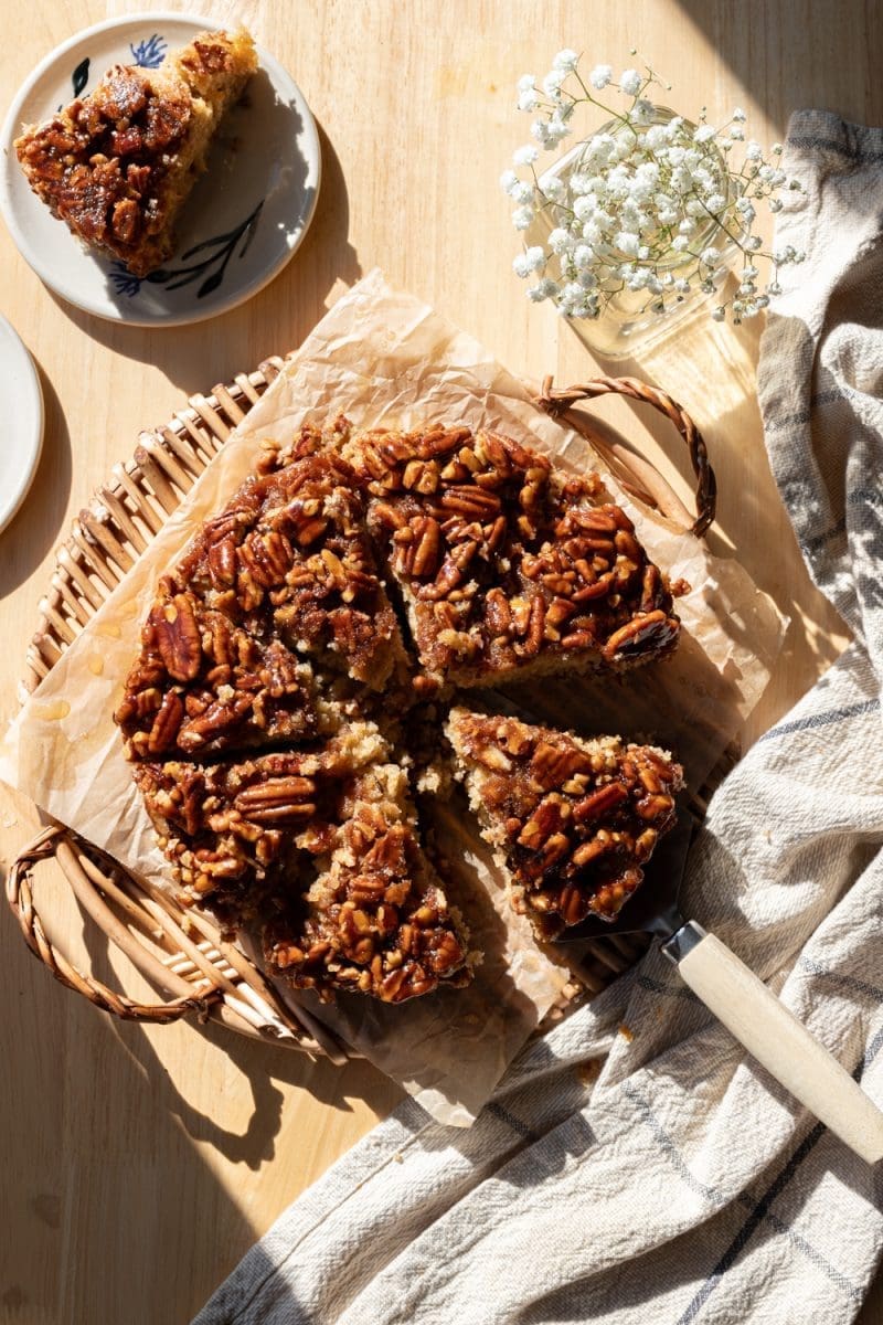 The banana pecan upside down cake sliced on a serving tray.