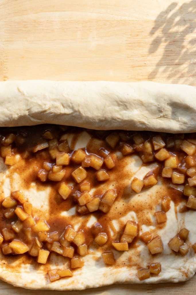 Rolling up the cinnamon rolls.