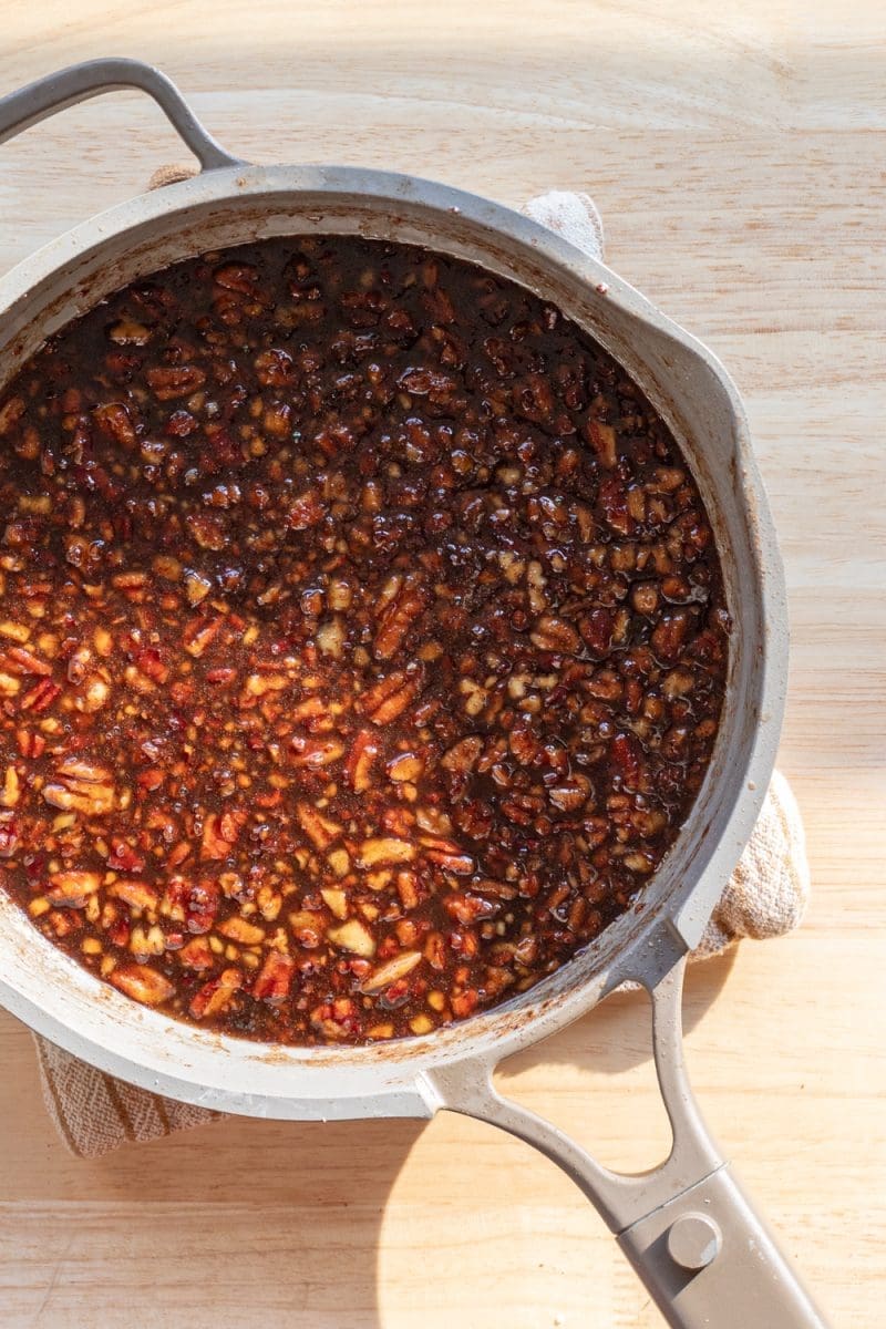The toasted pecan maple syrup in a saute pan.
