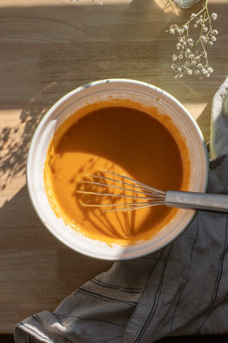 The wet ingredients beaten together in a mixing bowl.
