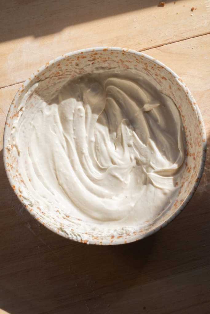 Maple cream cheese frosting in a mixing bowl.