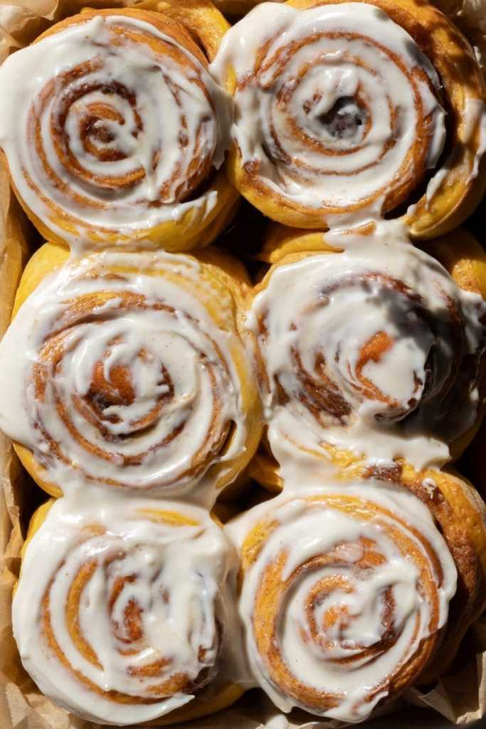 Close up of the frosted small batch pumpkin cinnamon rolls.