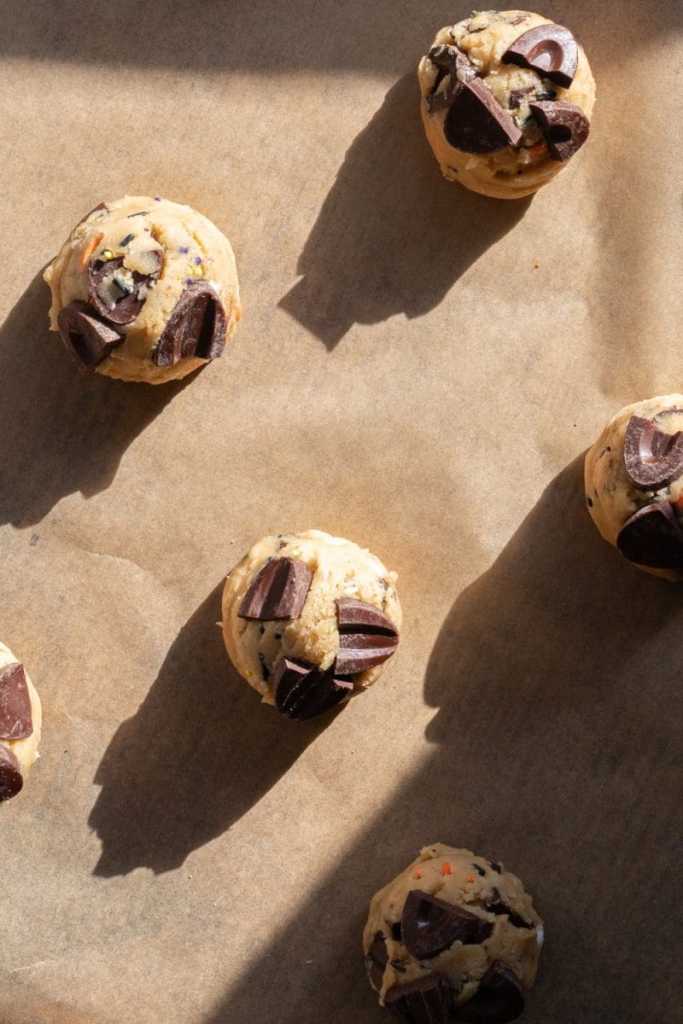 Scoops of cookie dough on a baking tray.