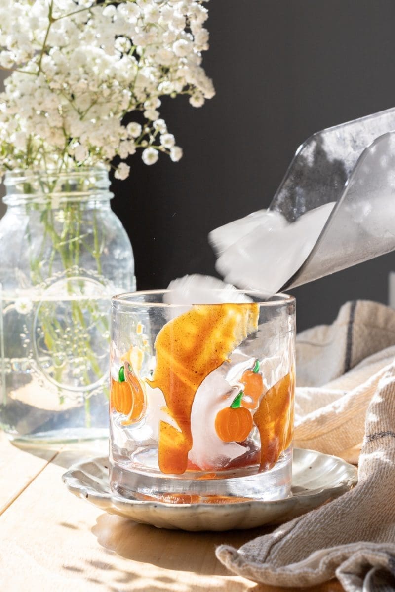 Adding ice into the cup.