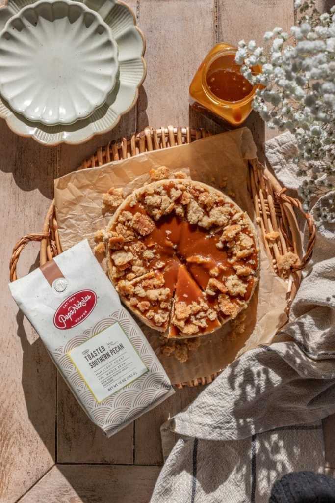 The chai caramel latte cheesecake next to a bag of coffee.