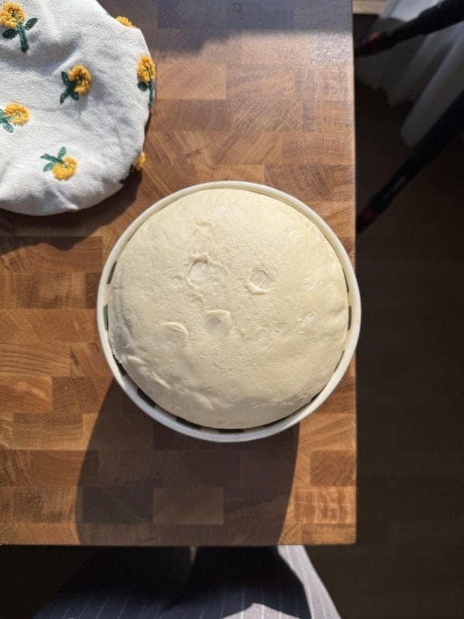 Brioche dough in a small bowl.