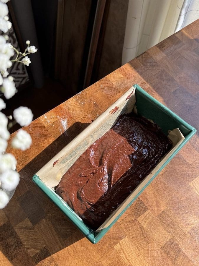 The fudge brownie batter in a prepared loaf pan.