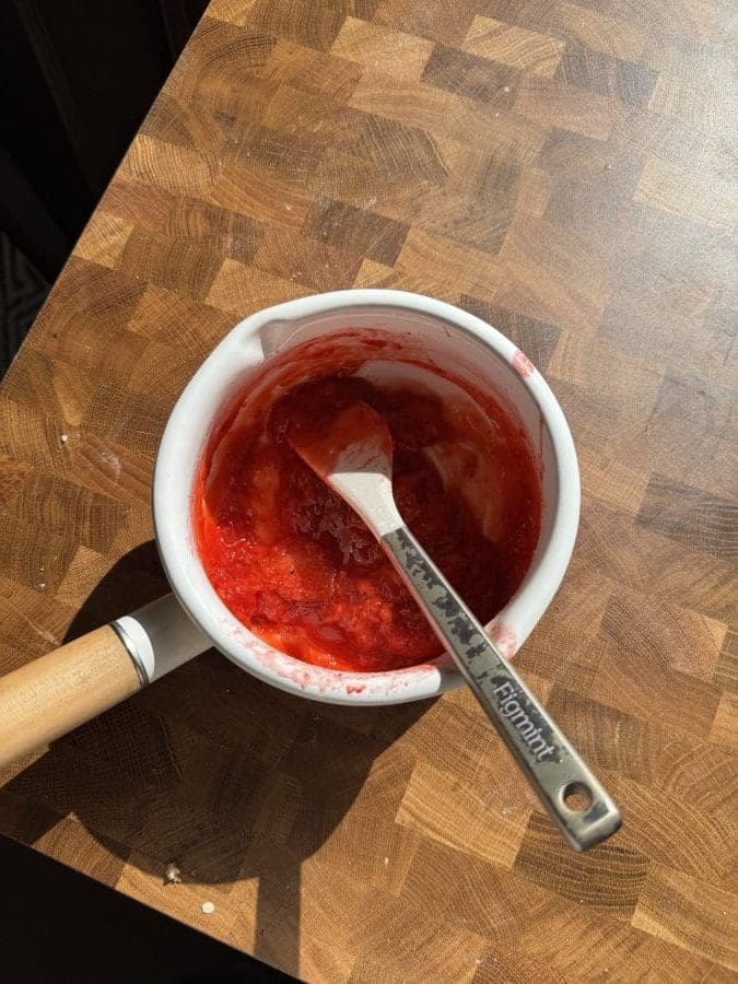Strawberry jam in a saucepan.