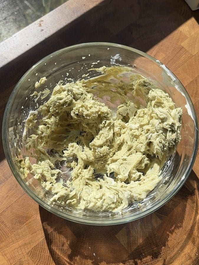 Pistachio mascarpone cream frosting in a large mixing bowl.