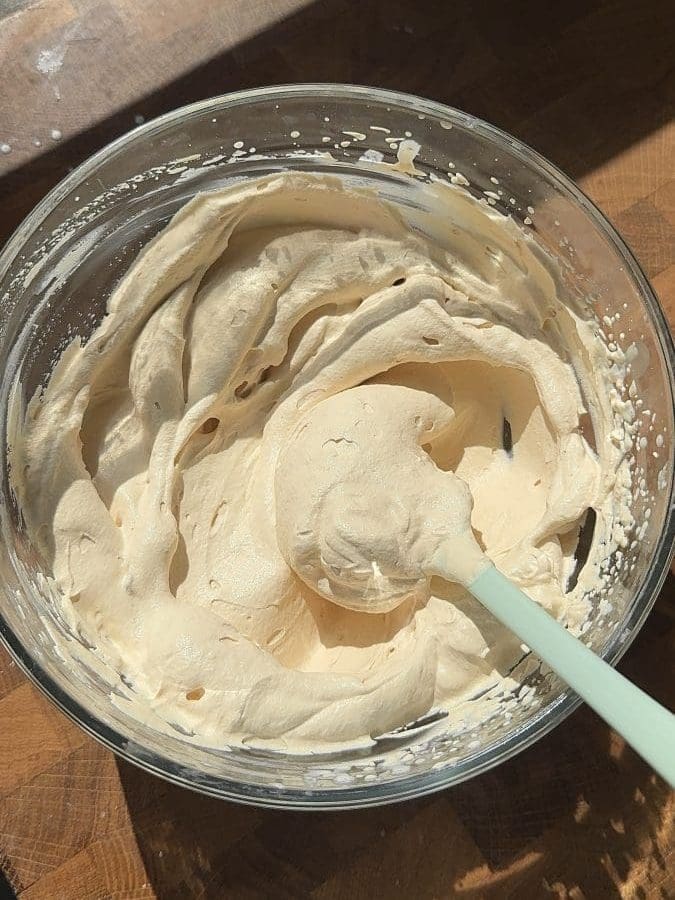 Dulce de leche whipped cream in a mixing bowl.
