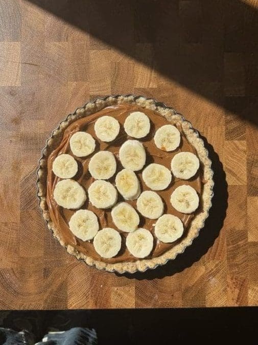 The bananas layered on top of the dulce de leche.