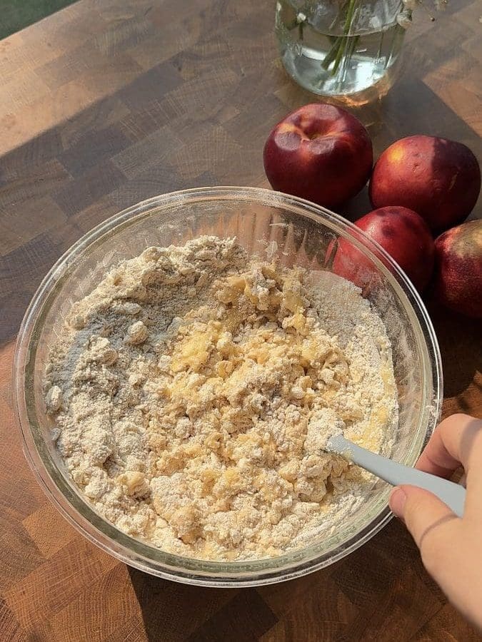 Folding the wet ingredients into the dry ingredients.