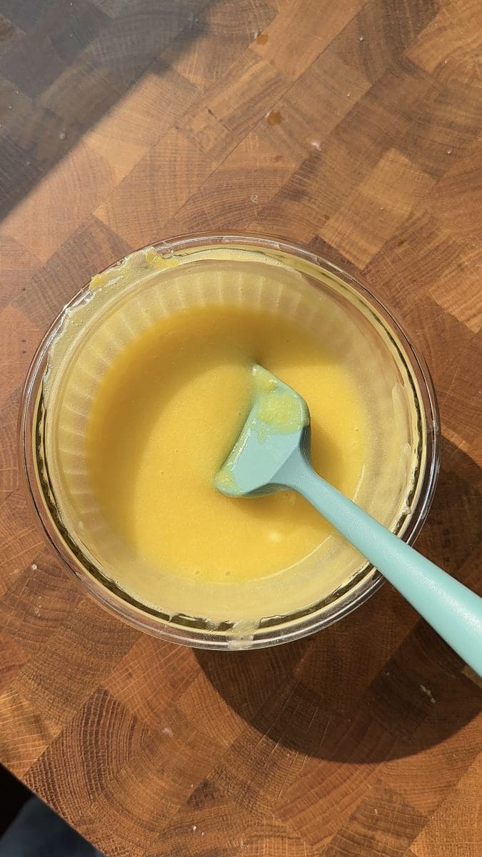 Lemon curd in a mixing bowl.