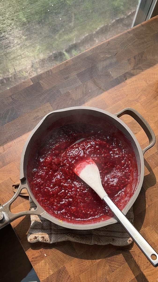 Raspberry jam in a saucepan.