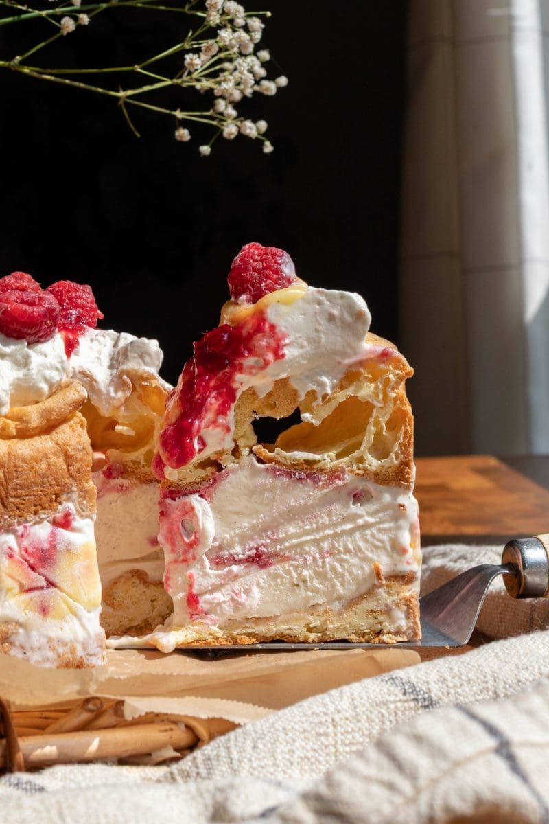 A slice of the lemon raspberry cream puff ice cream cake