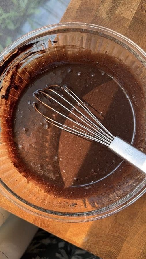 The wet ingredients of the chocolate cake whisked together.