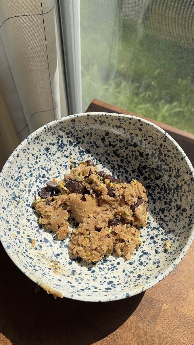 The finished pistachio chocolate chip cookie dough in a mixing bowl.