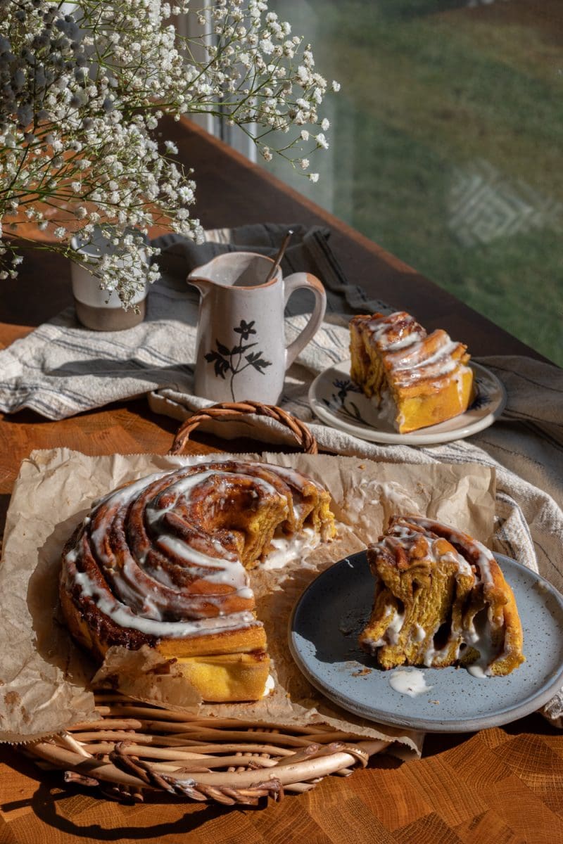 The giant pumpkin cinnamon roll stylized on a serving tray.