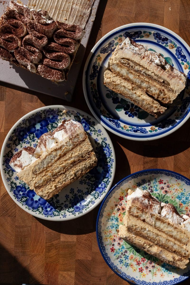 Slices of pumpkin tiramisu on decorative plates.