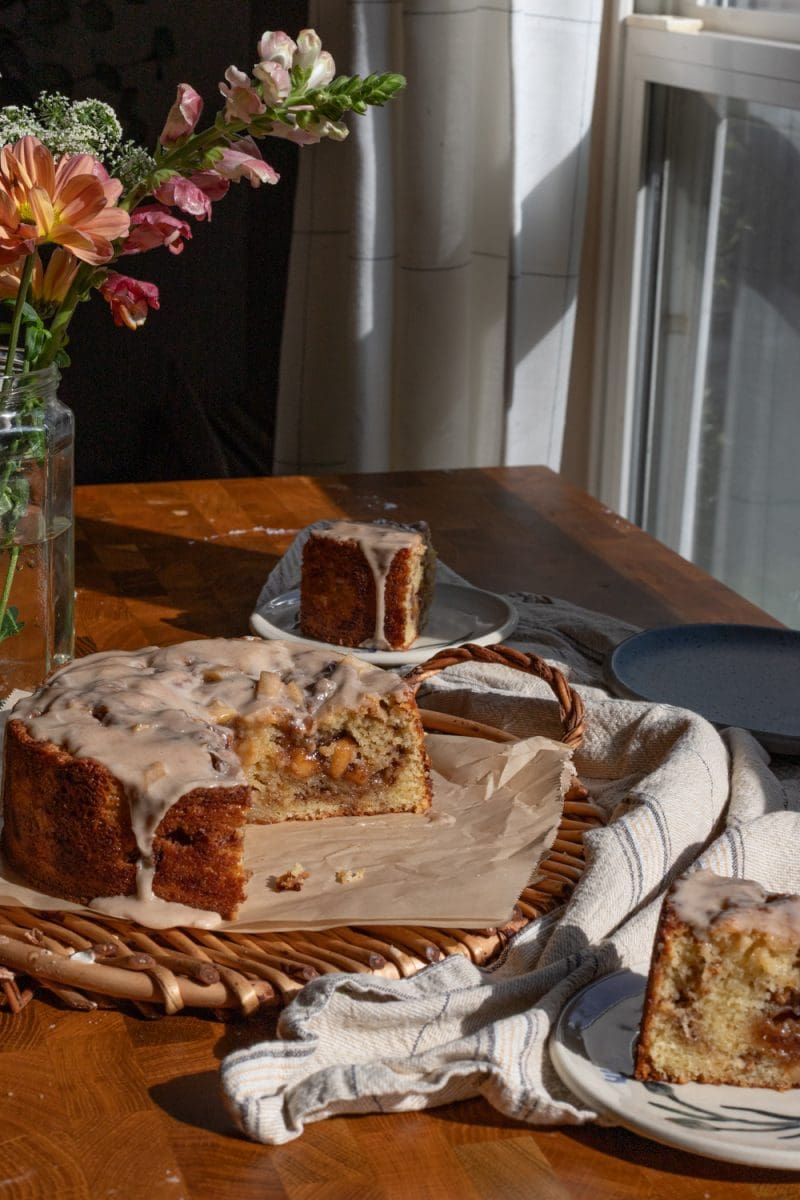 The apple fritter cake sliced on a tray.