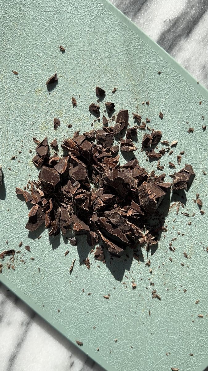 The chopped chocolate on a cutting board.