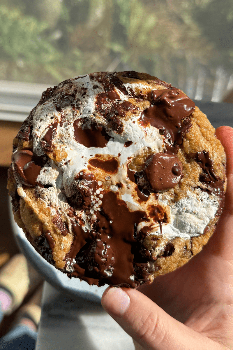 Holding up the single serve pumpkin chocolate chip cookie.