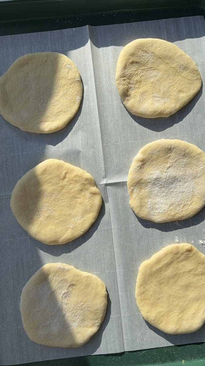 The dough rolled out into individual circles.