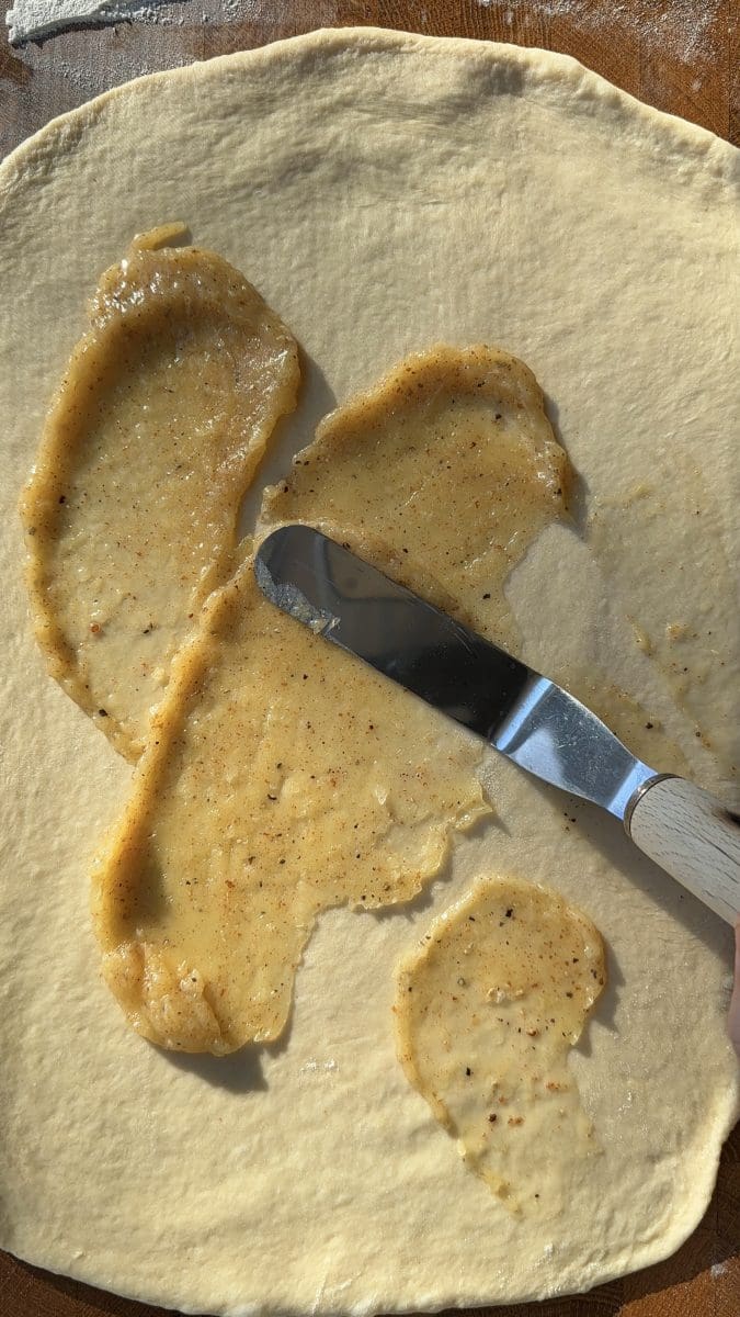 Spreading the filling over the dough.