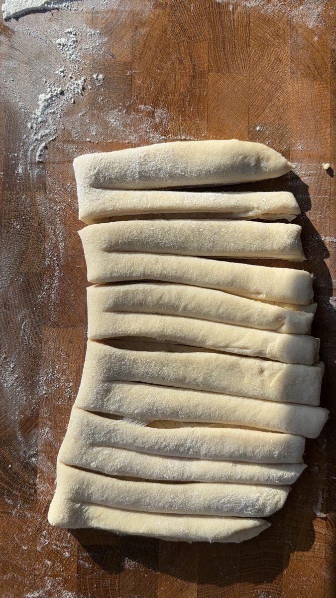 The dough sliced into strips.