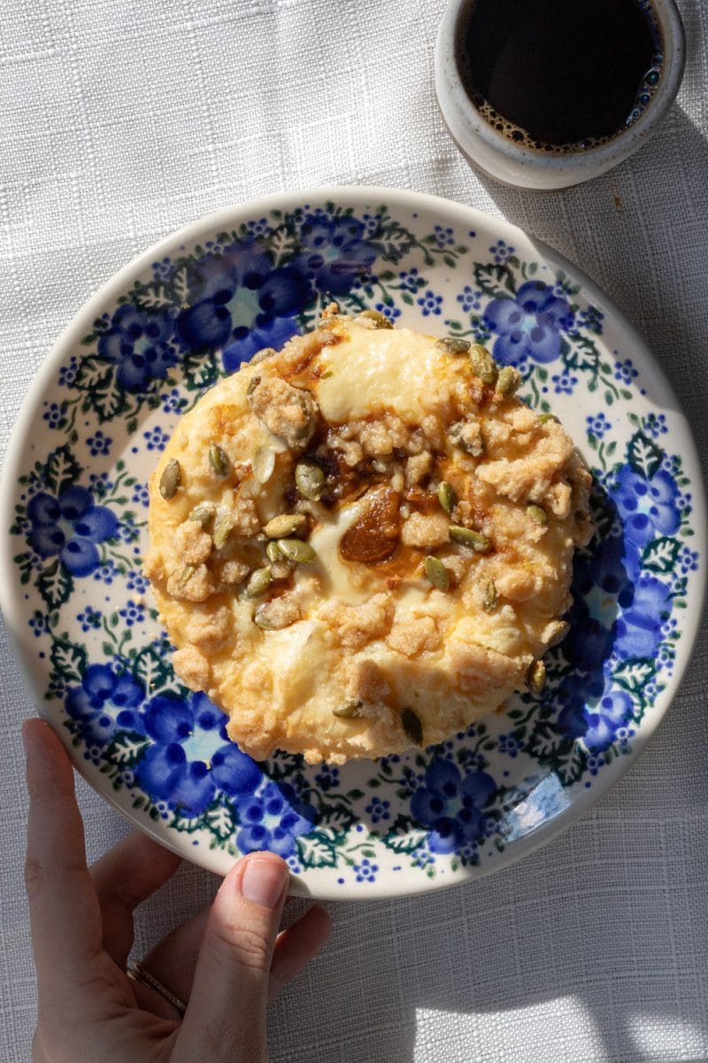 One of the pumpkin cheesecake brioche buns on a decorative plate.