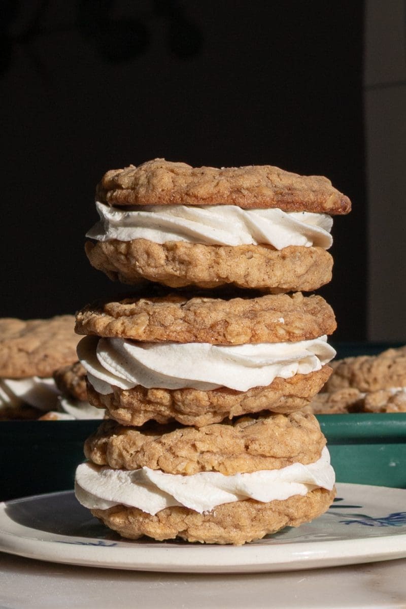 Close up of the coconut gingerbread oatmeal cream pies stacked on each other.