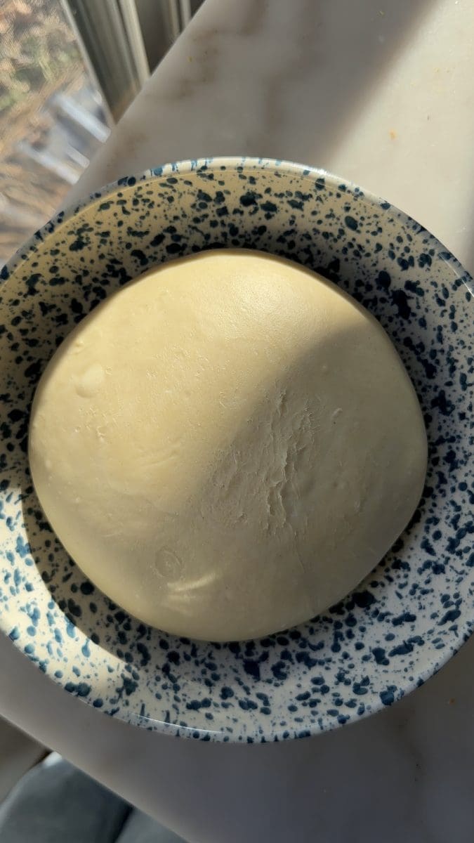 The milk bread dough in a mixing bowl.