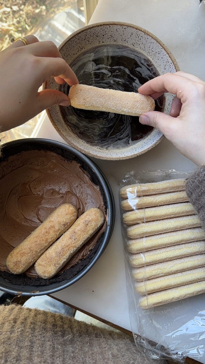 Dipping ladyfingers into the coffee soak.