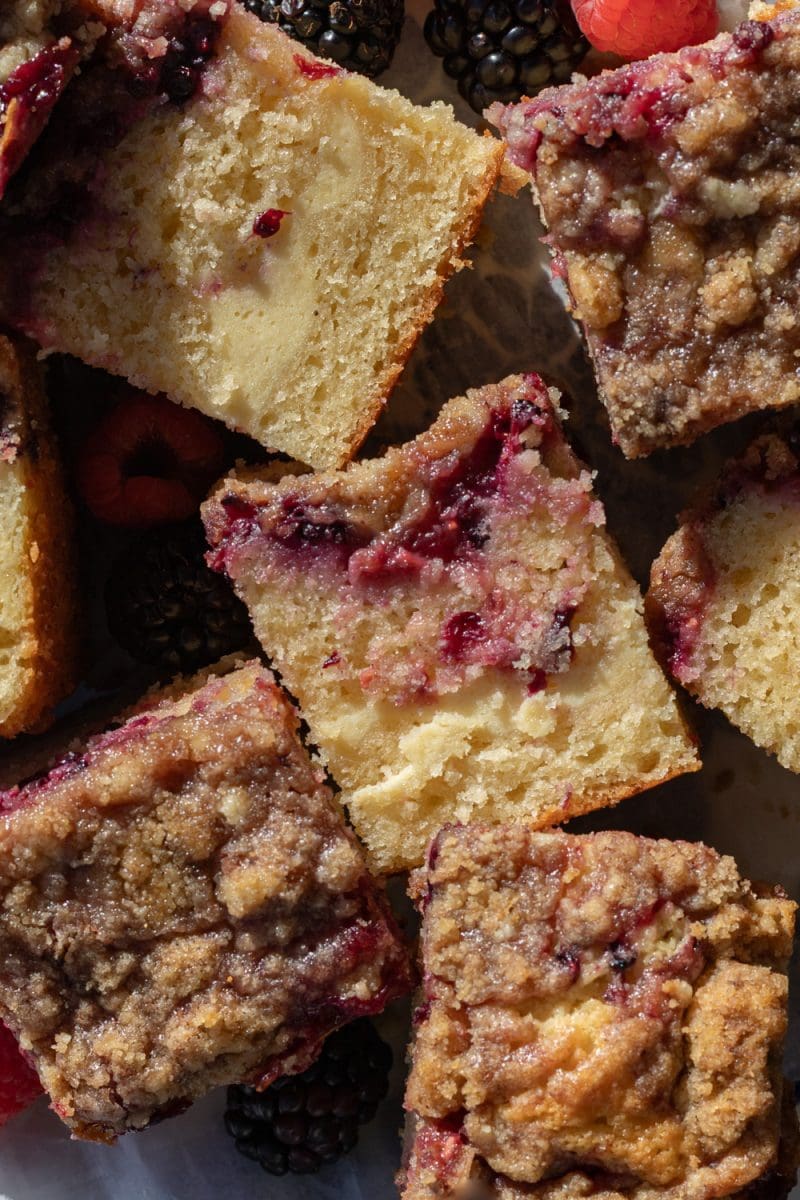 Close up of the slices of berry cream cheese crumb cake on a platter.